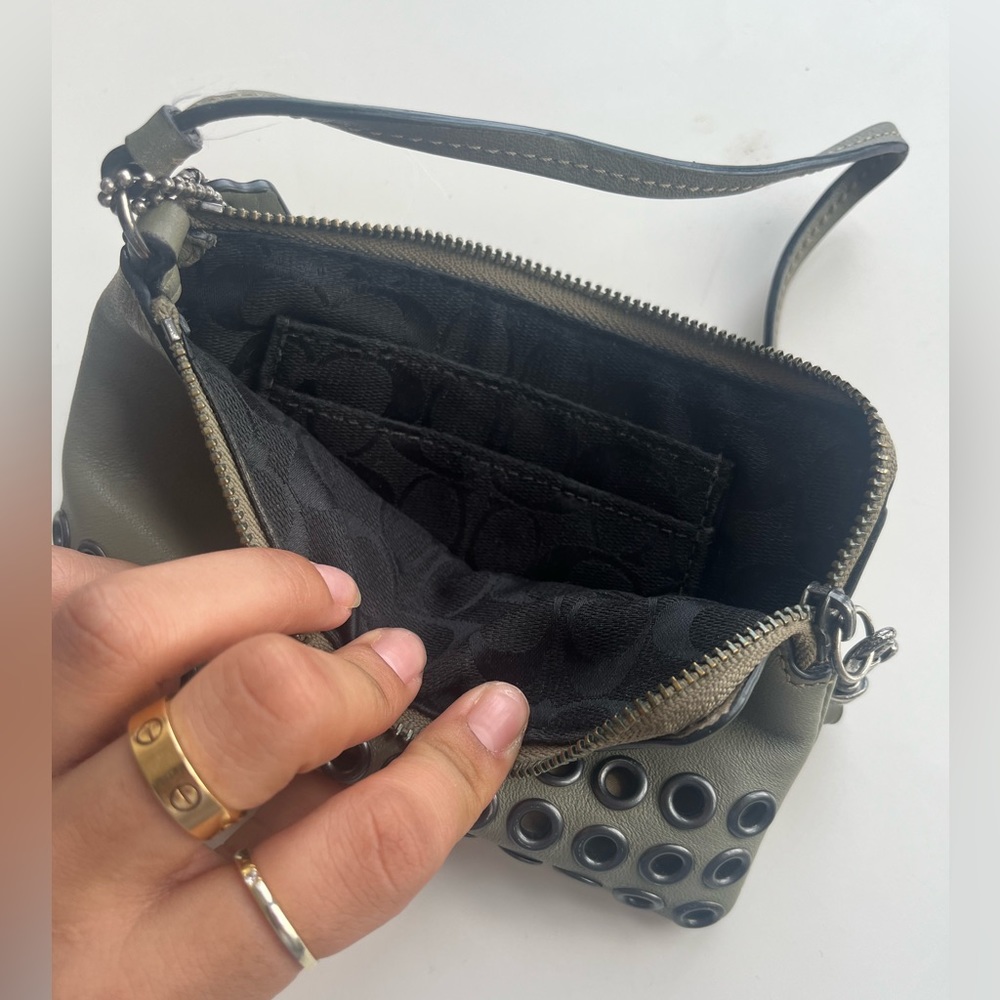 Coach Wristlet in grey with black helmet detailing
